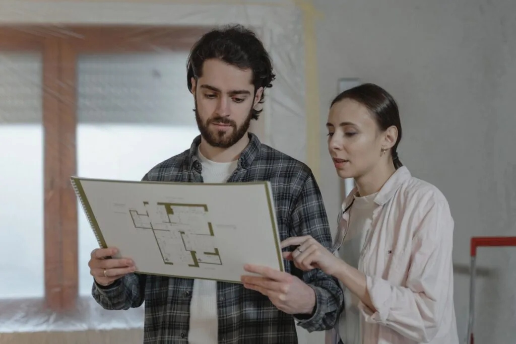 SOMO project lead reviewing a floor plan with a homeowner inside a Bay Area home being renovated