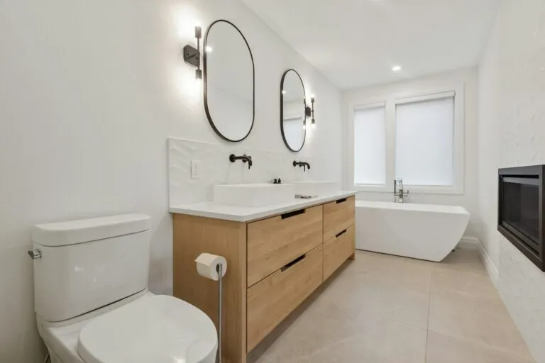 Remodeled bathroom with oak vanity and freestanding tub