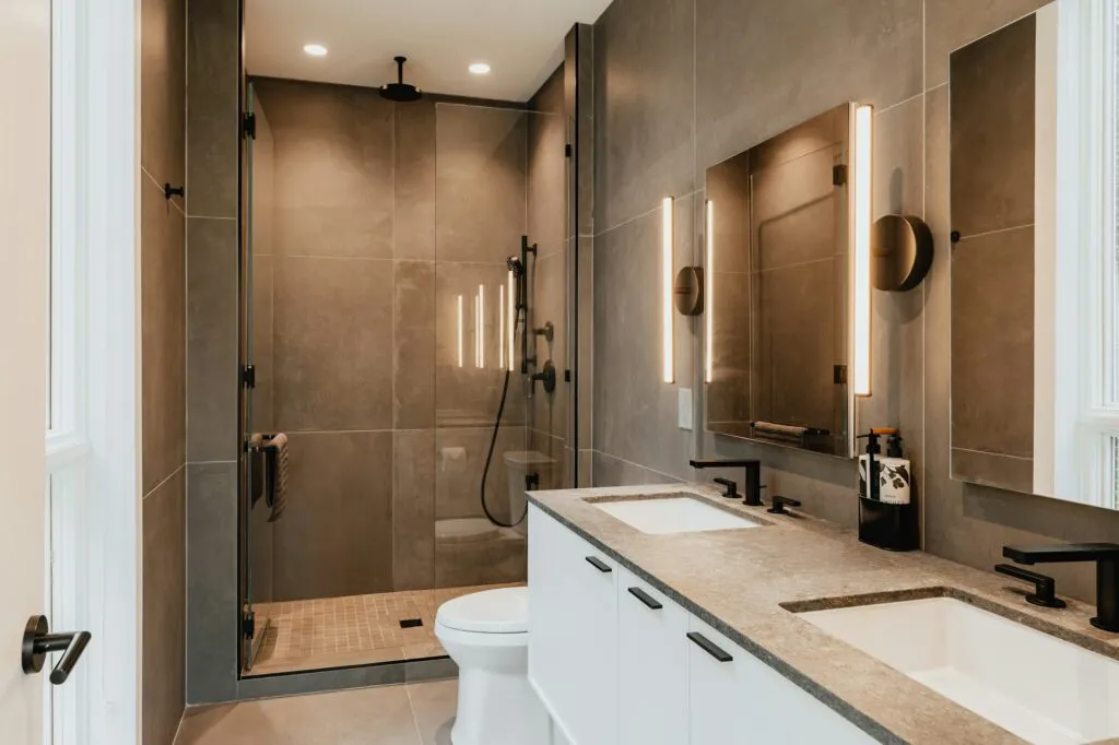 Walk-in shower with glass enclosure and double vanity