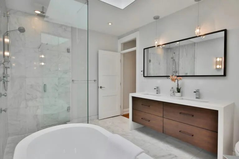 Marble bathroom with floating walnut vanity and glass shower