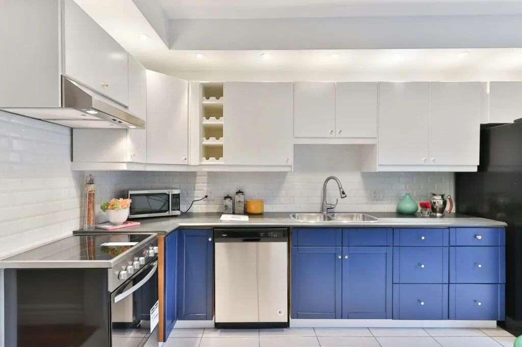Kitchen with refinished navy blue lower cabinets