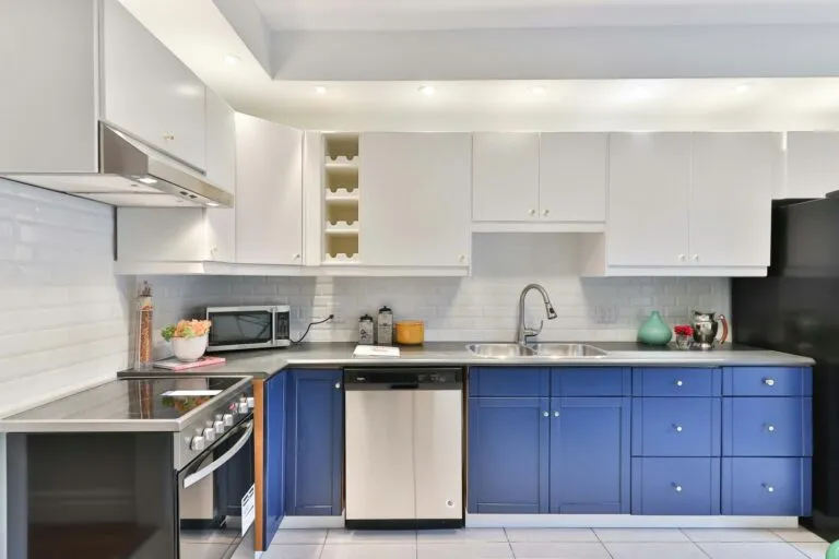 Kitchen with refinished navy blue lower cabinets