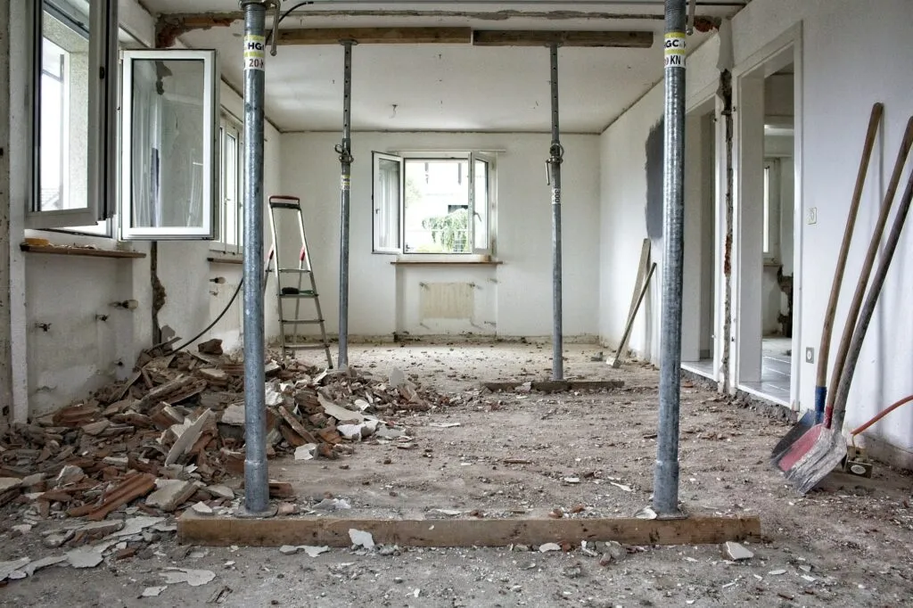 Gutted room with temporary shoring during restoration