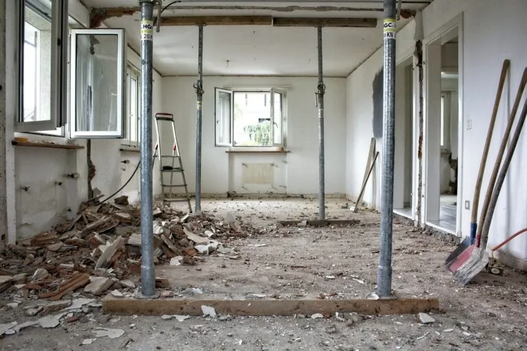 Gutted room with temporary shoring during restoration