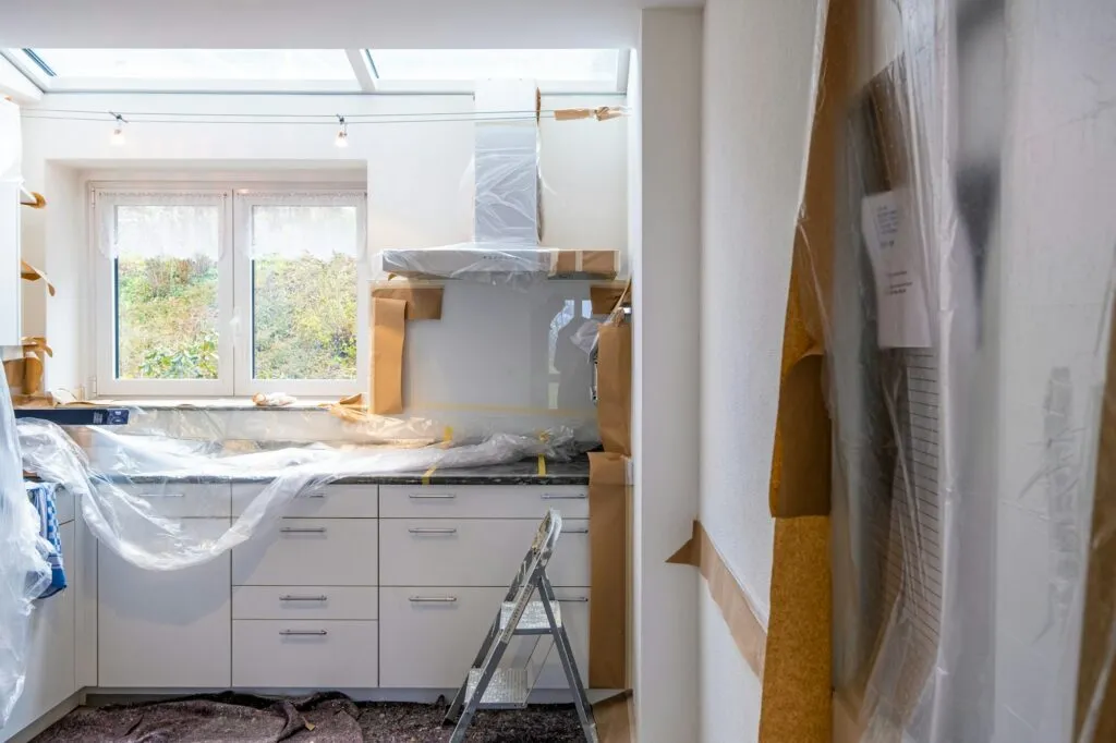 Kitchen work site protected with plastic sheeting