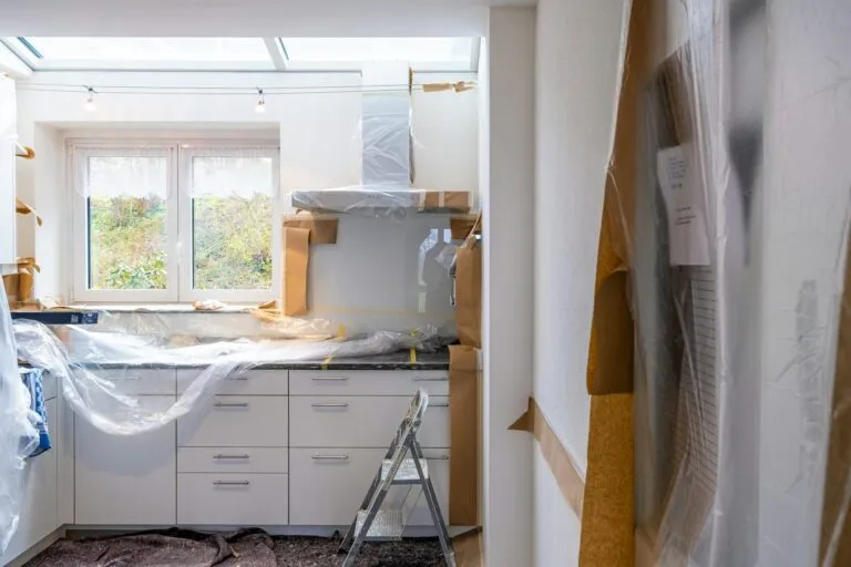 Kitchen work site protected with plastic sheeting